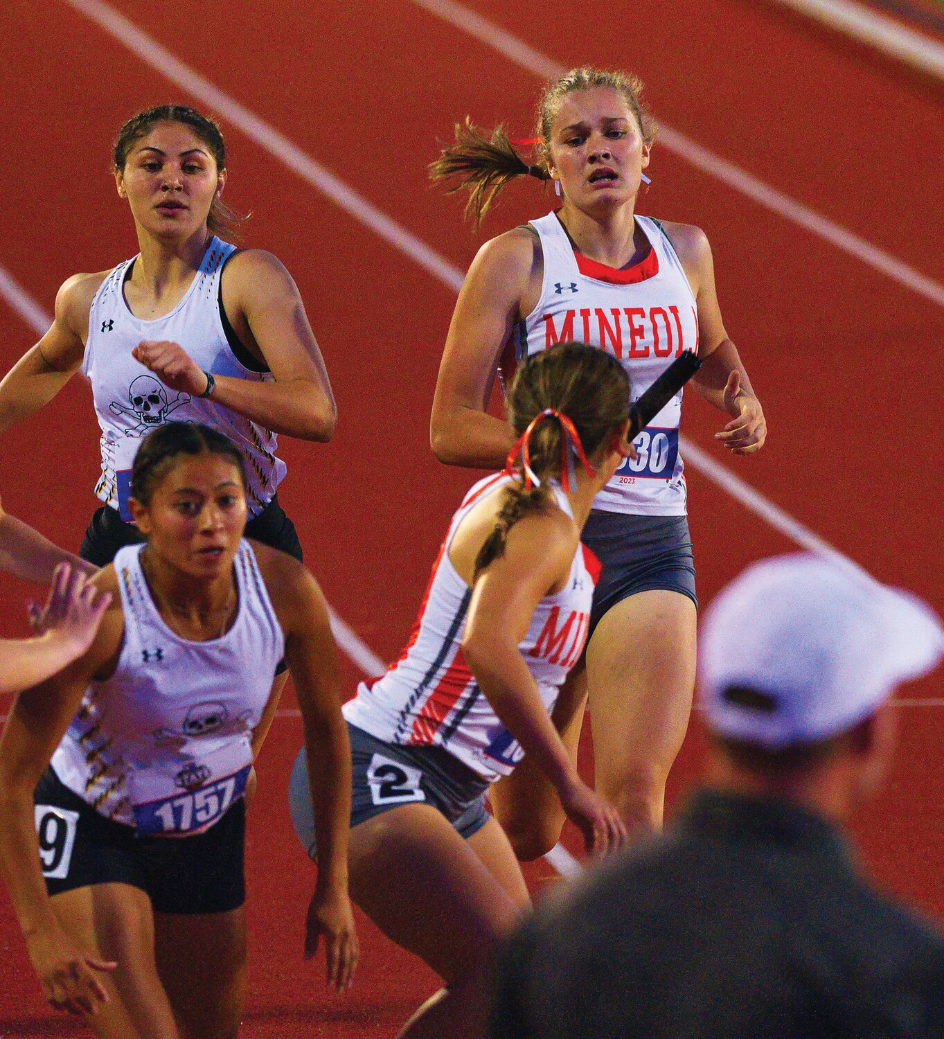 Tanner Hartzog approaches Carmen Carrasco for the final leg of the 1,600-meter relay. [view more relay running]